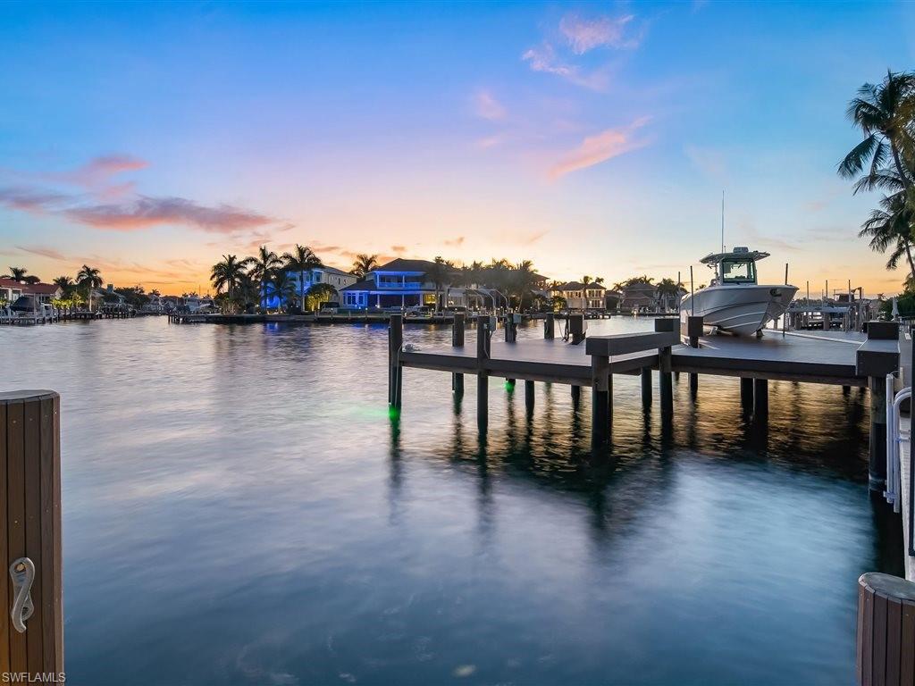 Dock area with a water view and boat lift