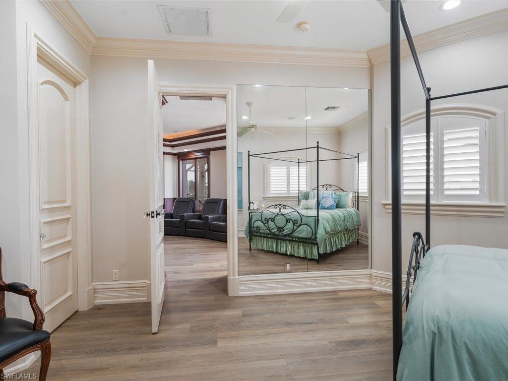 Bedroom featuring ornamental molding and light wood finished floors