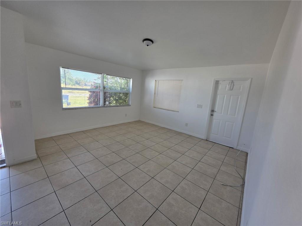 Unfurnished room with light tile patterned floors
