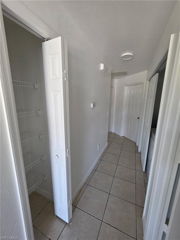 Corridor featuring light tile patterned floors