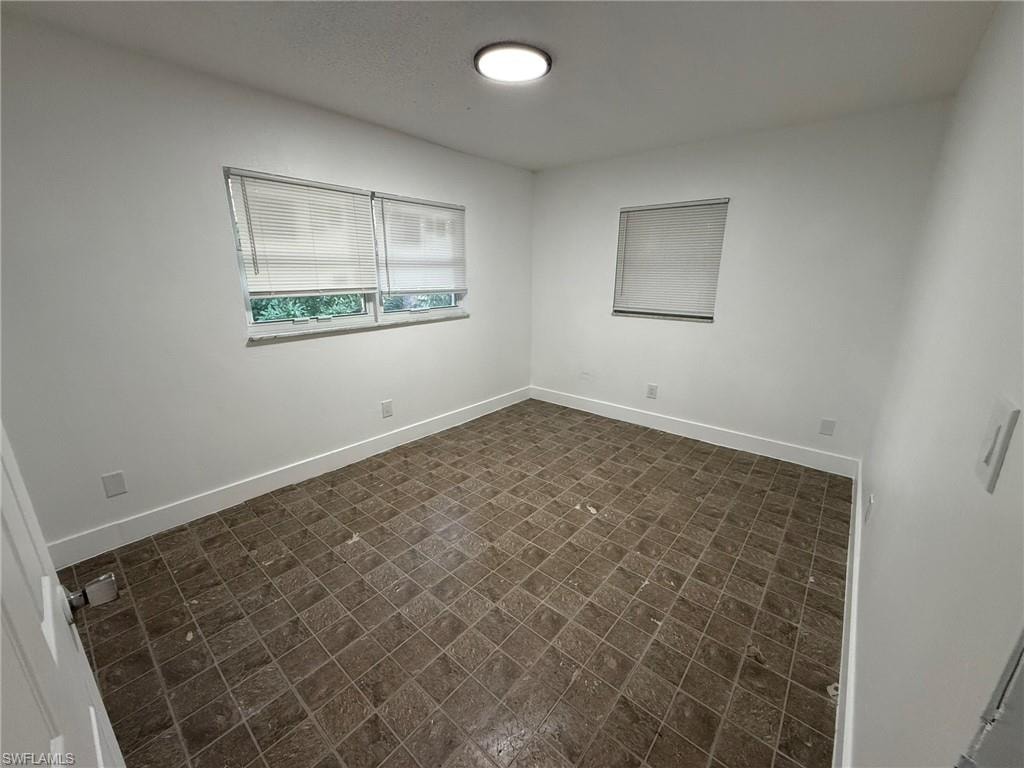 Unfurnished room with baseboards