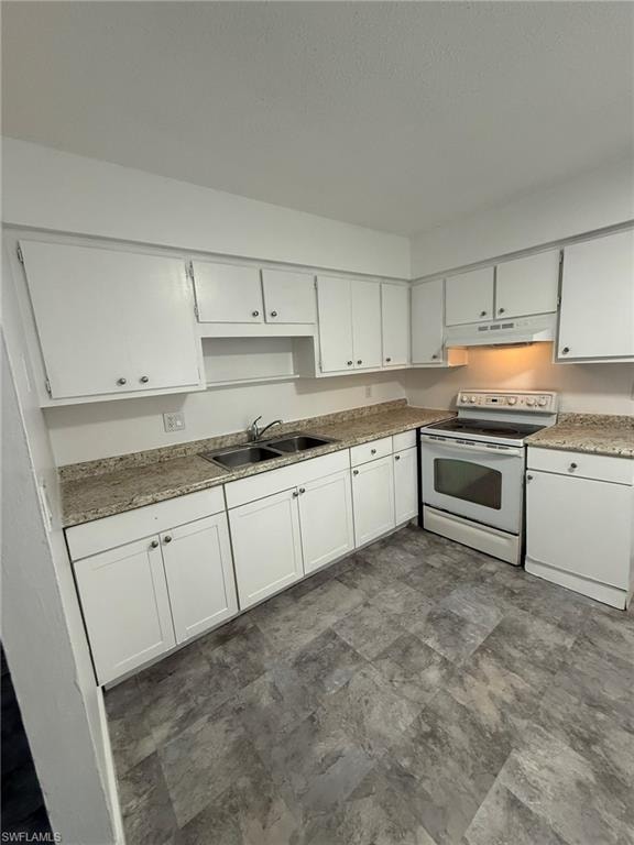 Kitchen with electric stove, white cabinetry, under cabinet range hood, and stone finish flooring