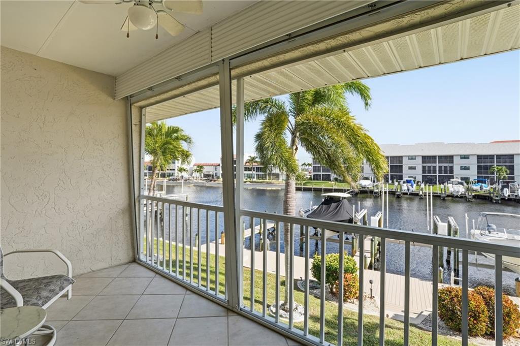 Balcony featuring a ceiling fan and a water view