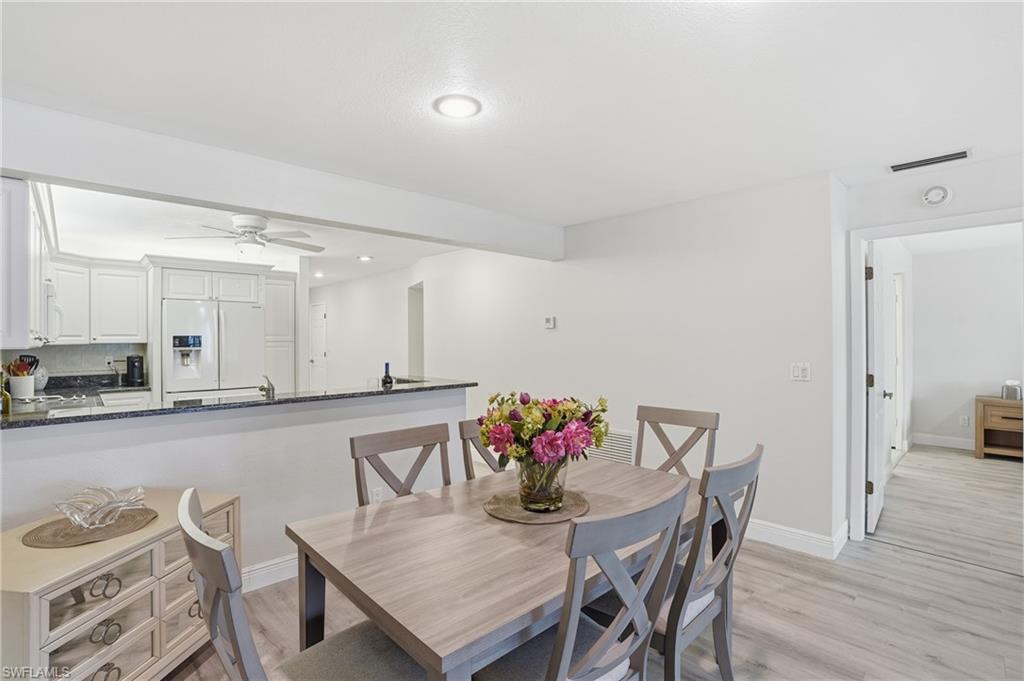Dining area featuring light LVPnfloors, a ceiling fan, and recessed lighting