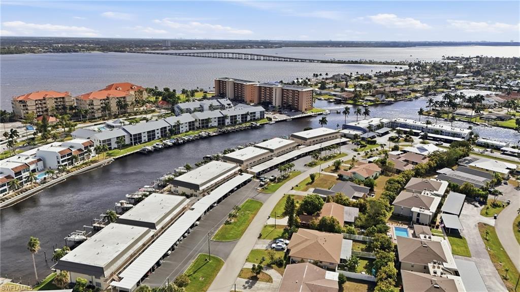 Aerial view of property and surrounding area with a nearby body of water and Cape Parkway Bridge