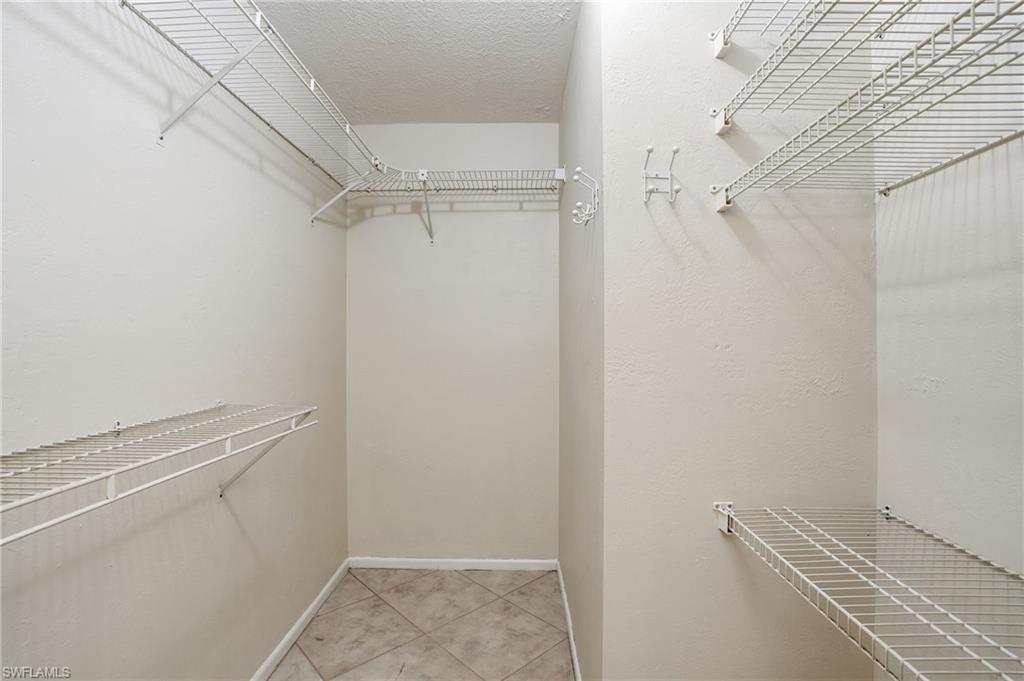 Walk in closet featuring light tile patterned flooring