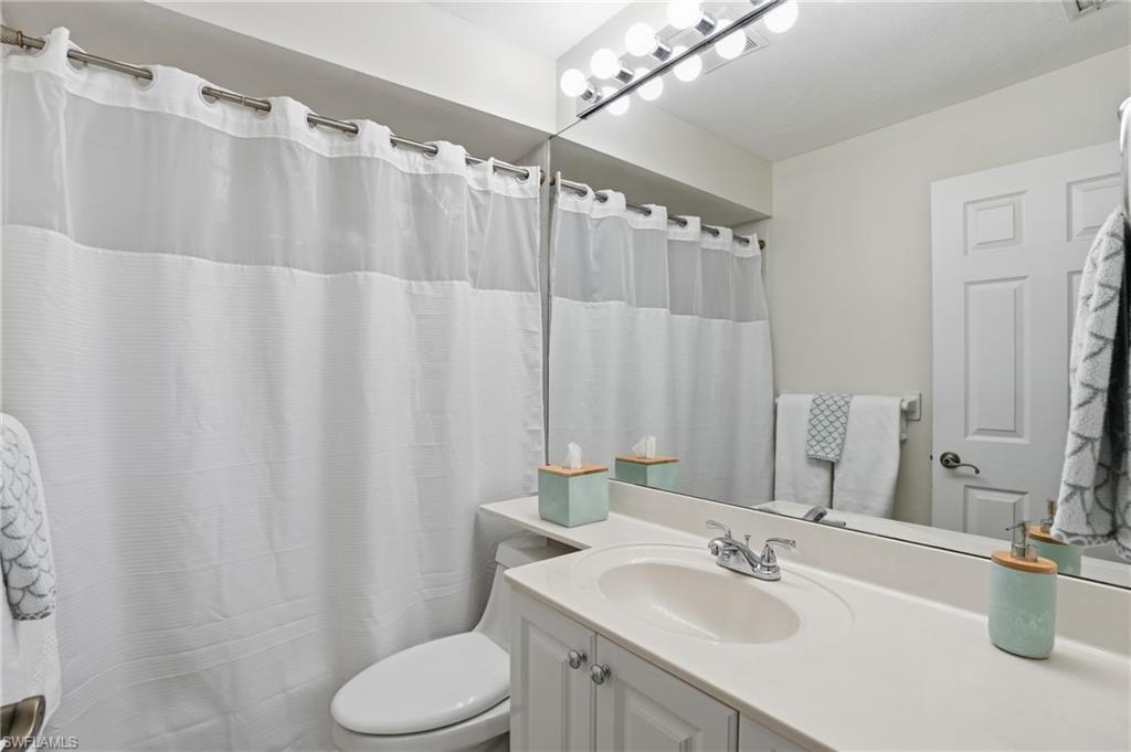 Full bathroom featuring curtained Tub and vanity