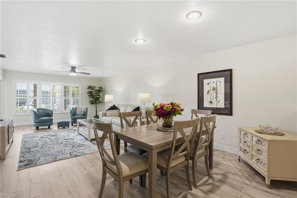 Dining area with light LVP flooring and ceiling fan