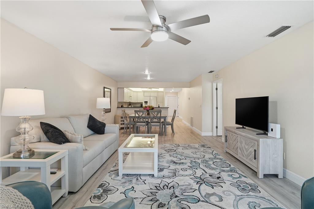 Living area featuring light LVP flooring and ceiling fan