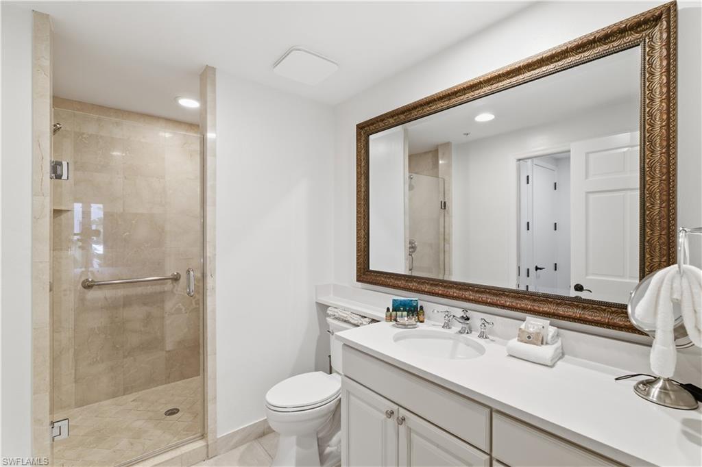 Full bathroom featuring vanity, a shower stall, and recessed lighting