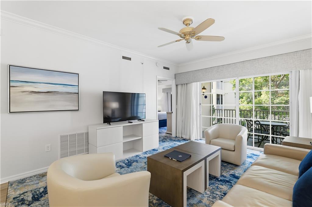Living area with crown molding and ceiling fan