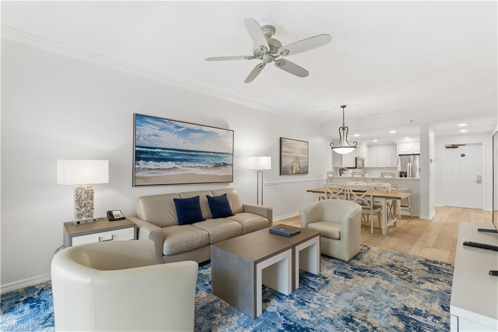 Living area with crown molding, ceiling fan, light wood-style flooring, and recessed lighting