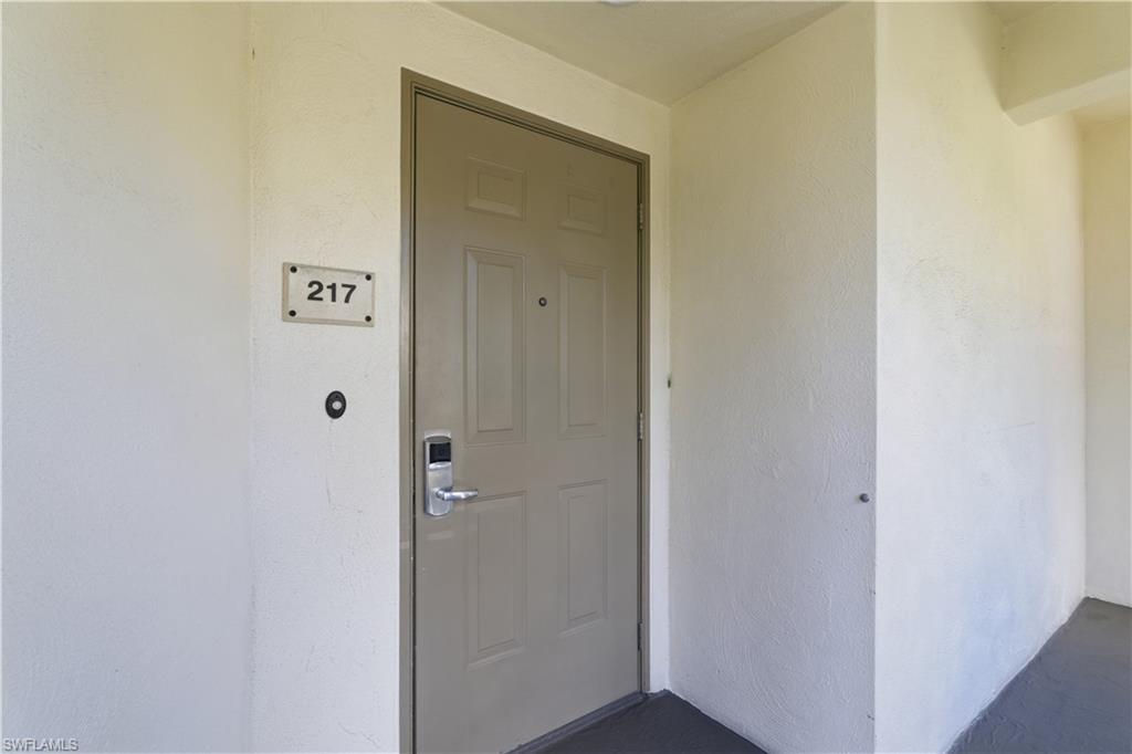 Property entrance featuring stucco siding