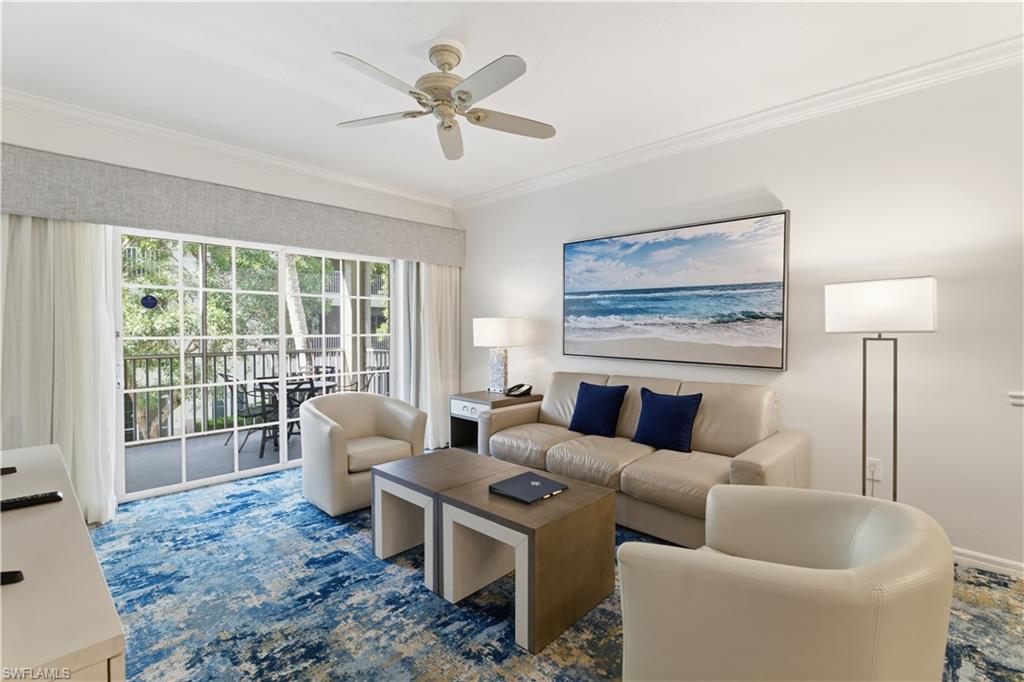 Living room with ornamental molding and ceiling fan