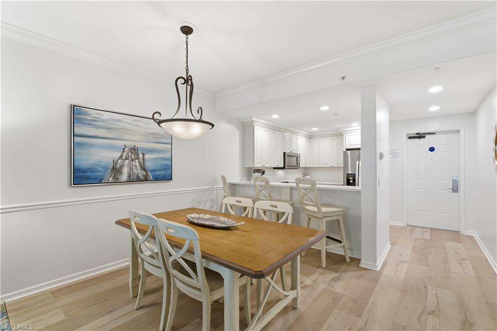 Dining space featuring recessed lighting, light wood finished floors, and crown molding