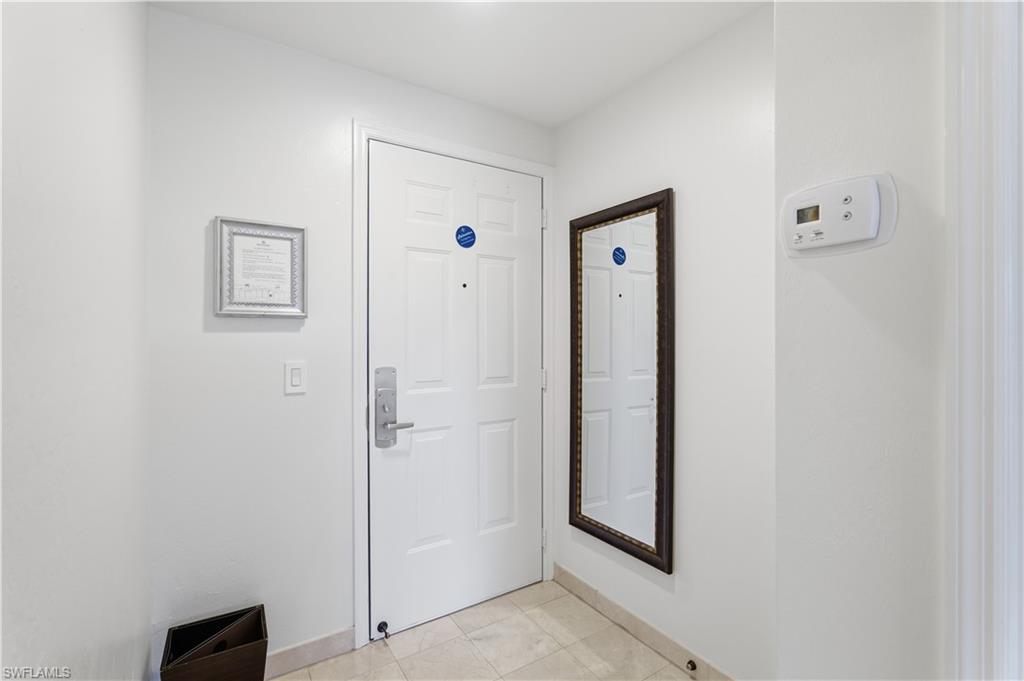 Doorway featuring baseboards
