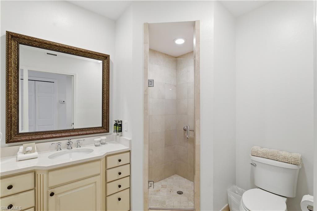 Bathroom with a stall shower and vanity