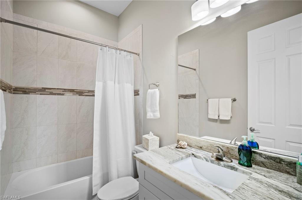 Full bathroom featuring shower / bath combo and vanity