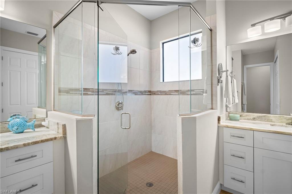 Full bath with vanity and a shower stall