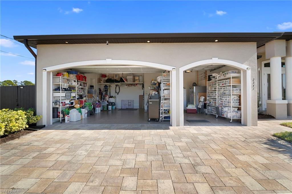 Garage featuring decorative driveway