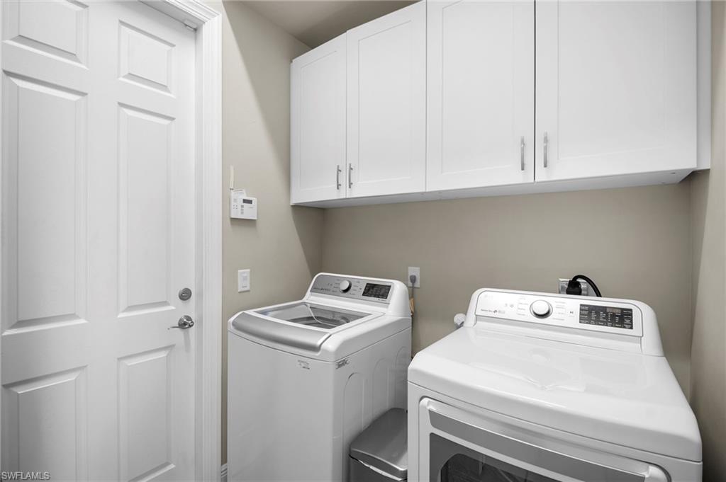 Laundry area with independent washer and dryer and cabinet space