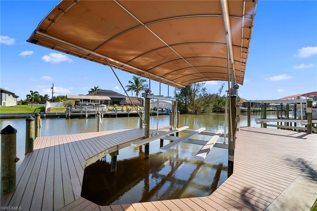 Dock area with boat lift and a water view
