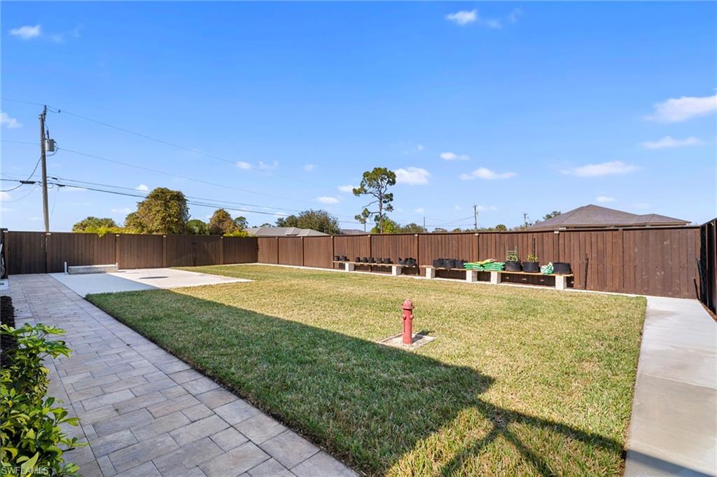 Fenced backyard with a patio