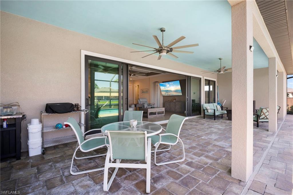View of patio featuring outdoor dining space, an outdoor living space, and a ceiling fan
