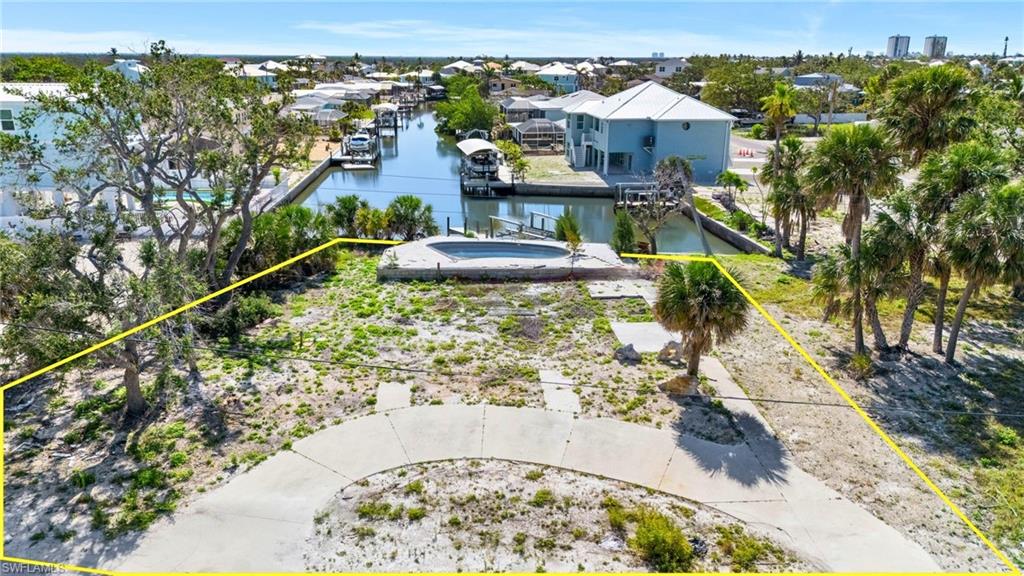 Aerial view of property's location featuring a large body of water and property boundaries highlighted  - Virtually Edited Image