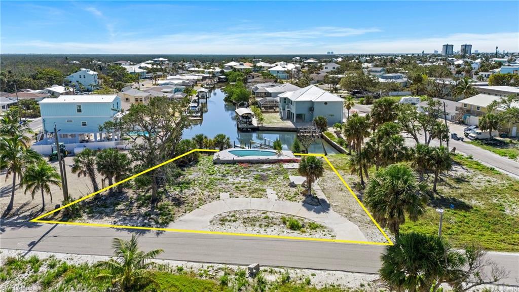 View of property location featuring a large body of water and property boundaries highlighted  - Virtually Edited Image