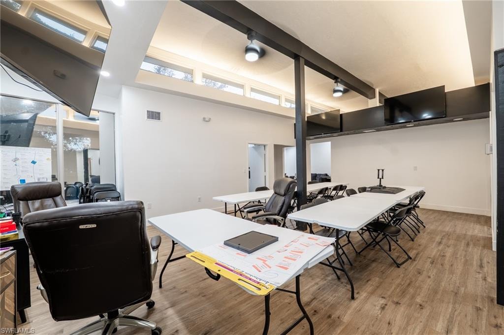 Office area with beamed ceiling and high vaulted ceiling