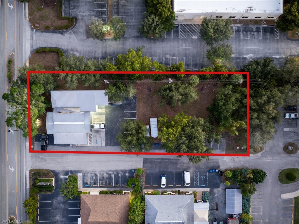 Aerial view of property and surrounding area featuring property parcel outlined