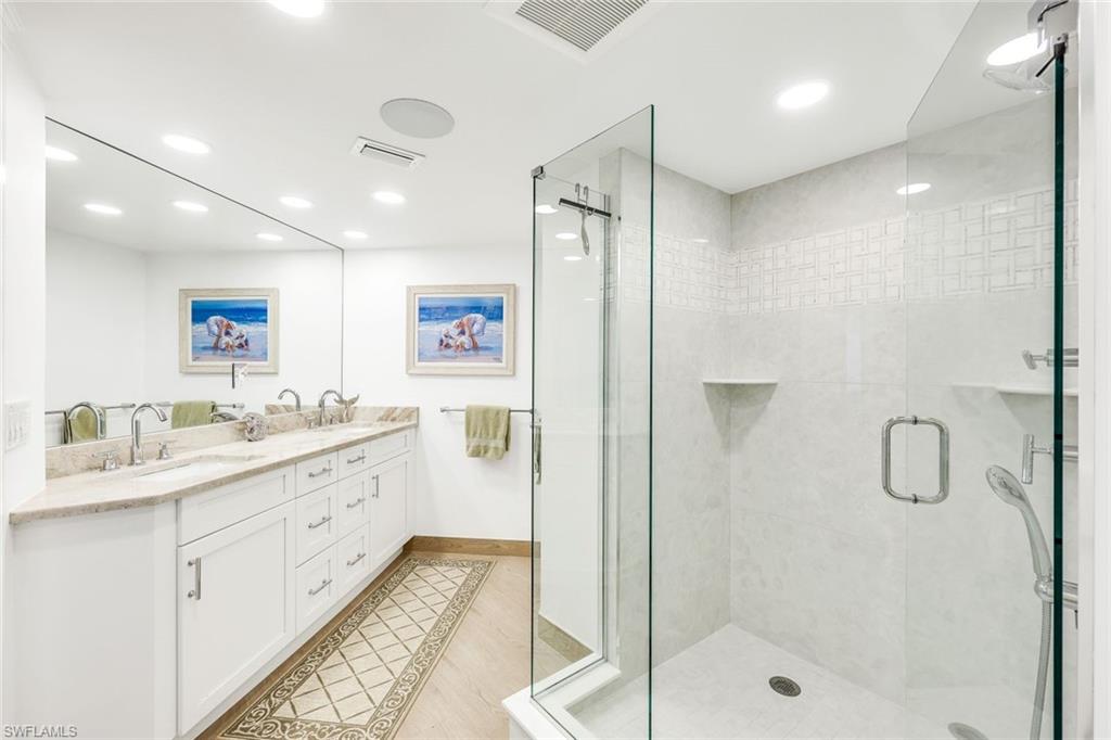Bathroom featuring vanity and a shower with shower door