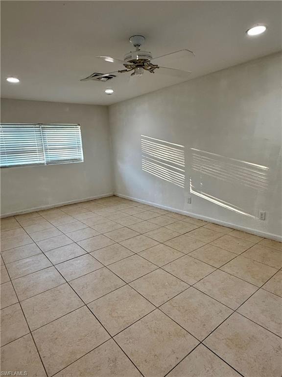 Unfurnished room with recessed lighting, light tile patterned floors, and ceiling fan