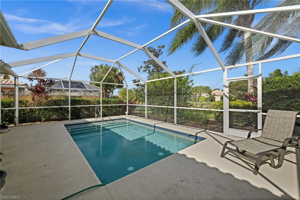 Swimming pool featuring a lanai, a sunroom, and a patio area