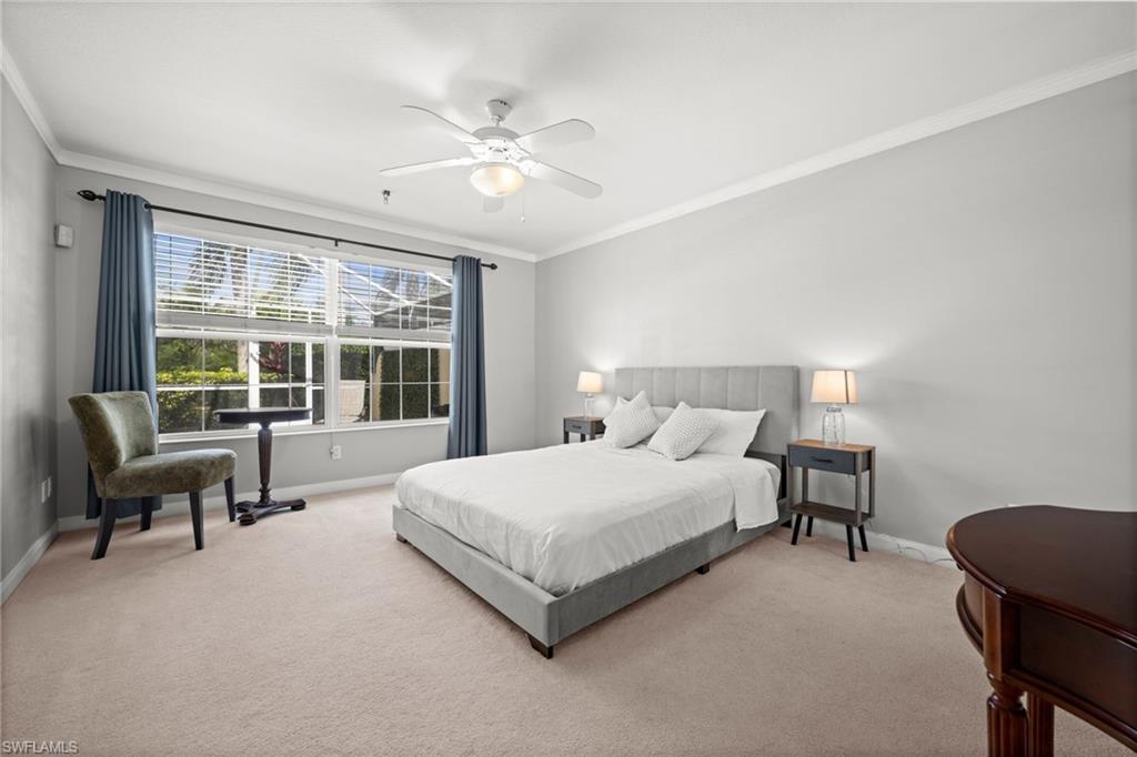 Bedroom featuring crown molding, carpet, and a ceiling fan