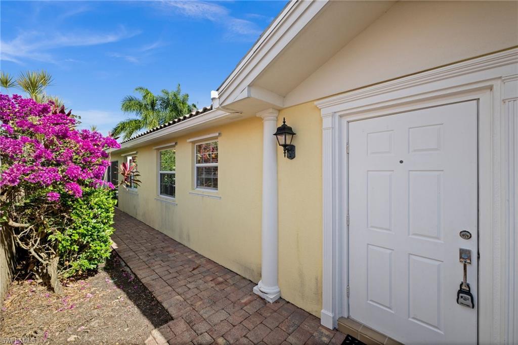 View of exterior entry with stucco siding