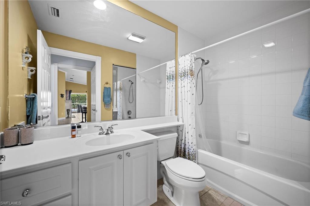 Full bathroom featuring vanity, shower / tub combo, and tile patterned floors