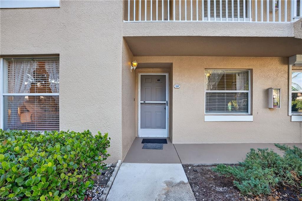 Entrance to property with stucco siding