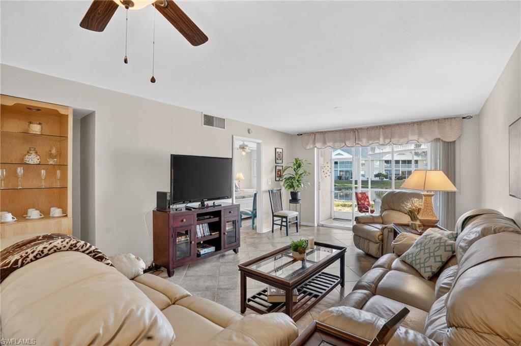 Tiled living room with a ceiling fan