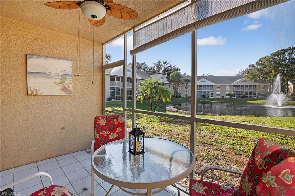 Sunroom with a water view, healthy amount of natural light, and a ceiling fan