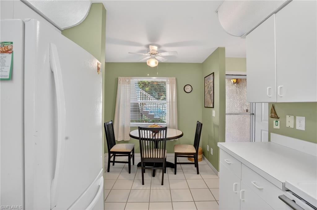 Dining area with light tile patterned floors and ceiling fan