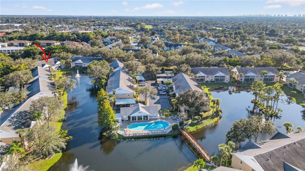 Aerial perspective of suburban area featuring a large body of water