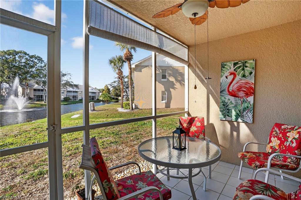Sunroom / solarium with a water view and ceiling fan
