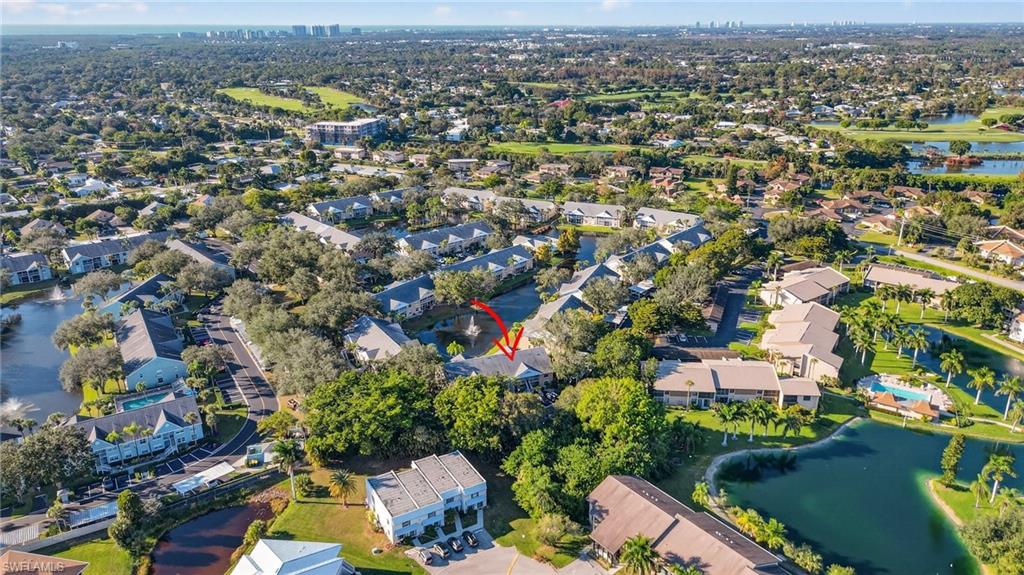 Aerial view of property's location featuring a large body of water and nearby suburban area