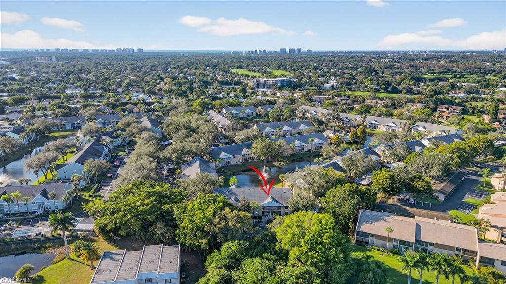 Aerial view of property and surrounding area featuring nearby suburban area and nearby urban area