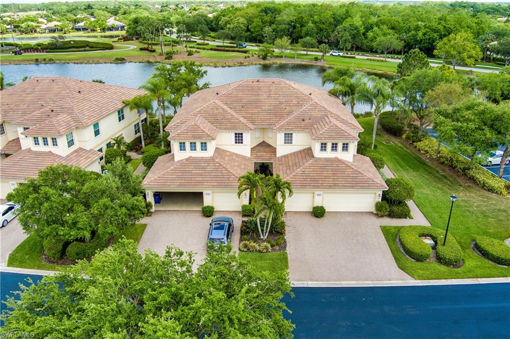 View from above of property featuring a large body of water and a tree filled landscape