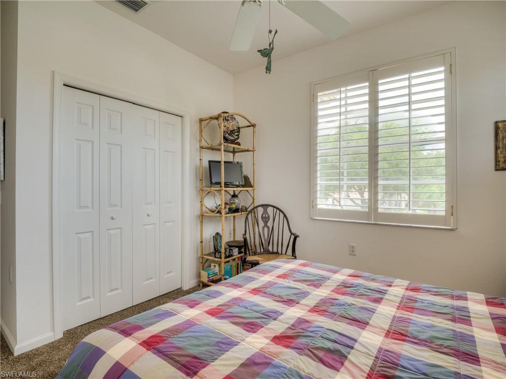 Bedroom featuring carpet, a ceiling fan, and a closet