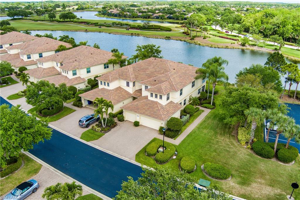 Aerial view of residential area with a large body of water and a golf course