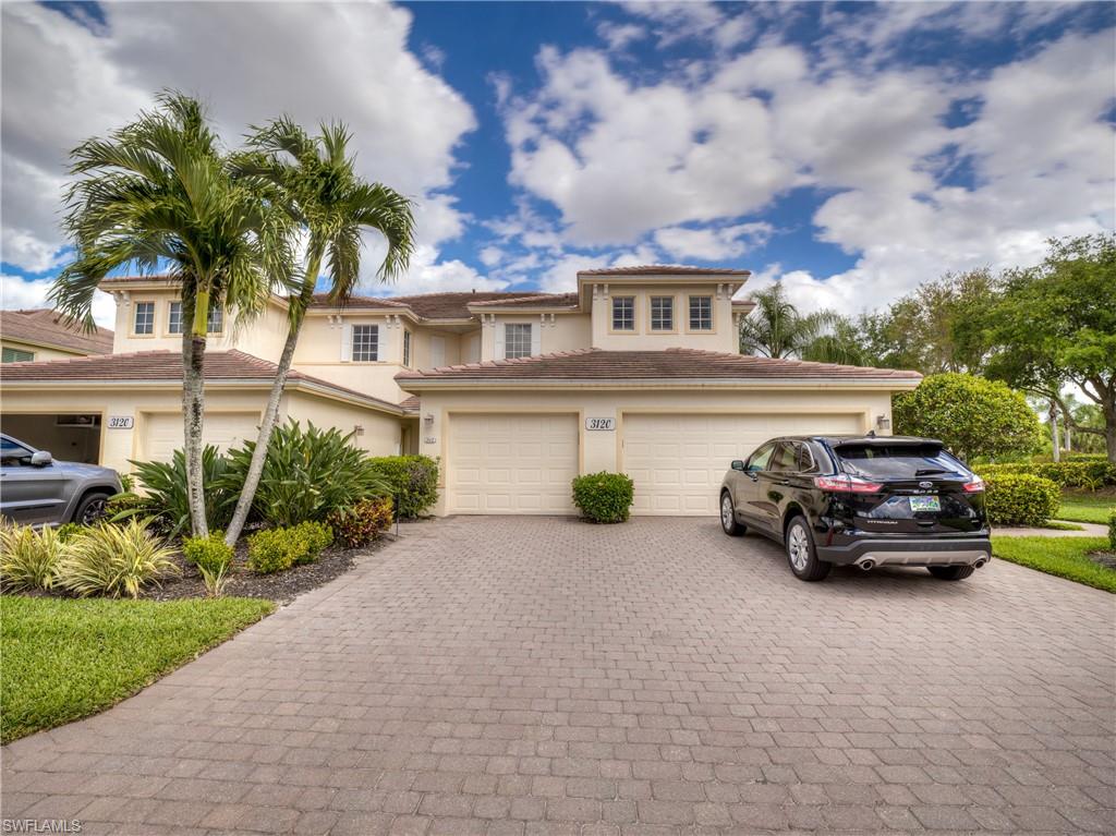 Mediterranean / spanish-style house with decorative driveway, stucco siding, a garage, and a tiled roof